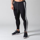 Muscle fitness men's sports pants men's trousers outdoor fitness exercise training feet Slim streetwear casual pants jinquedai